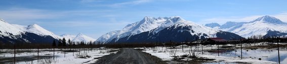 Alaska, Dirt road with snowy mountains behind