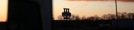 Arkansas freeway, Memphis To Little Rock, Adult store xxx sign in silhouette.