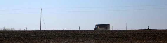 Illinois, postal truck driving through dust