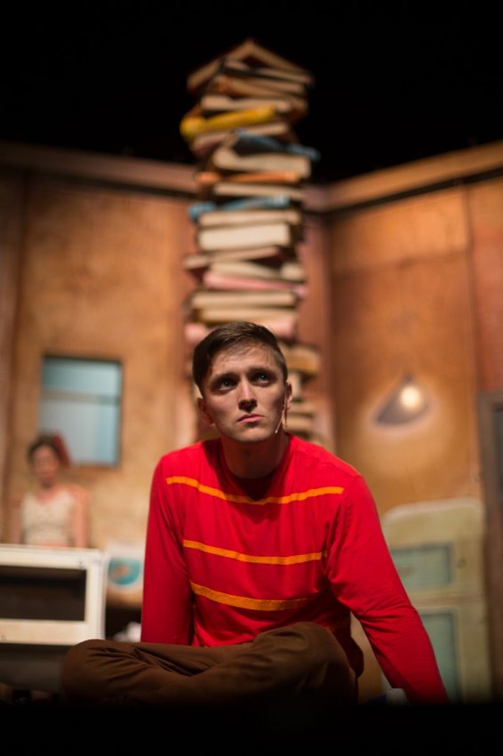 Gabriel Fancourt in The Incredible Book Eating Boy. Produced by CDP Theatre Producers. Lighting Design by Toby K.